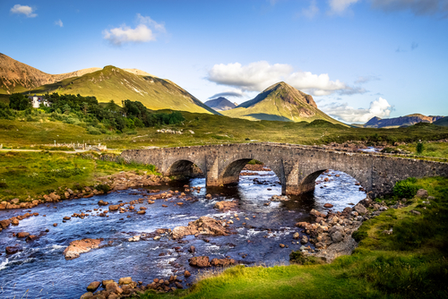 Old vintage brick bridge crossing river in Sligachan, Isle of Skye, Scotland, UK