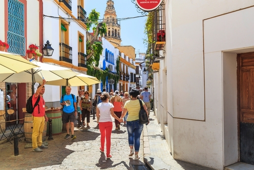 Unidentified tourists inspect the houses and streets of the medieval Jewish Quarter (Juderia) of Cordoba, Andalusia, Spain