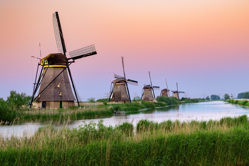 Sunset over of Kinderdijk windmills, famous tourist attraction, Holland