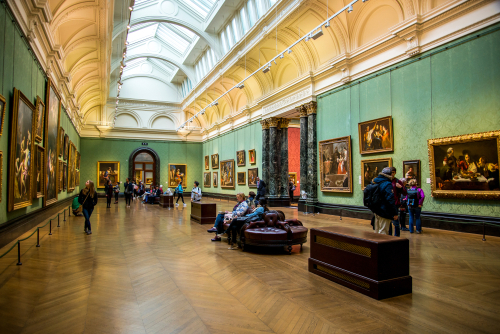 A long scenic hall and visitors in National Portrait Gallery in London, England, United Kingdom