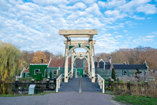 Double drawbridge with typical dutch houses in the background, in Dutch open air museum in Arnhem, Holland
