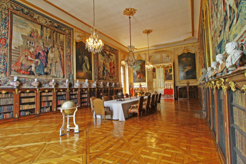 Rich interior of an old library in Palais Rohan, former residence of prince-bishops and cardinals of House of Rohan, ancient French noble family, with many bookshelves, Strasbourg, Alsace, France
