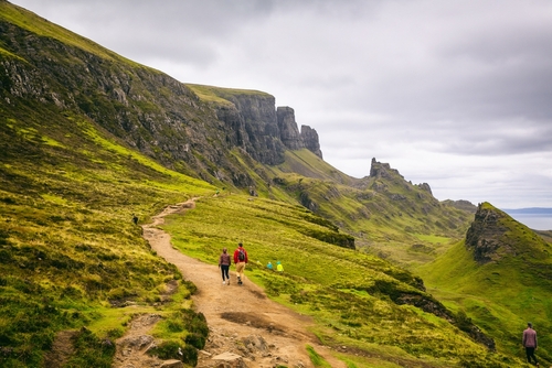 Beautiful view of people walking a path with spectacular scenery of the Quiraing on the Isle of Skye in summer, Scotland, UK