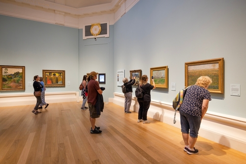 People looking at art inside the Scottish National Gallery in Edinburgh, Scotland, UK