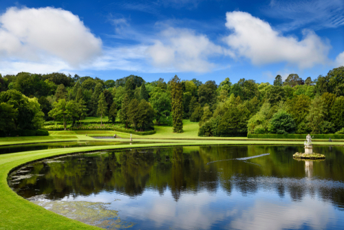 Studley Royal Water Garden Moon Pond with Neptune sculpture on the River Skell at Fountains Abbey, Ripon, Yorkshire Dales National Park, Yorkshire, England, UK