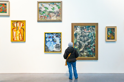 A person looking at paintings at the Tate modern gallery museum in London, England, United Kingdom