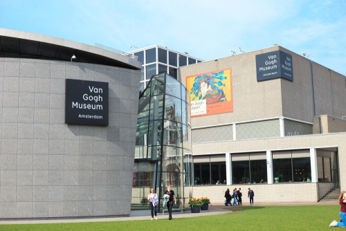 The Van Gogh Museum building complex on the Museum Square in Amsterdam, The Netherlands. Poster announcing the exhibition 