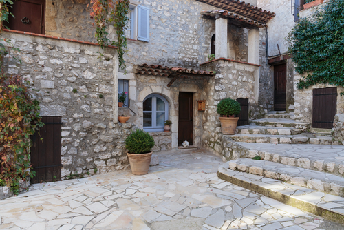 Narrow-cobbled streets with flowers in the old village Gourdon in the French Riviera, Cote d'Azur, France