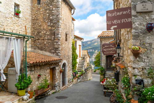 Narrow-cobbled streets with flowers in the old village Gourdon in the French Riviera, Cote d'Azur, France