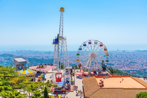 People are enjoying a Sunny day at Tibidabo amusement park in Barcelona, Catalonia, Spain