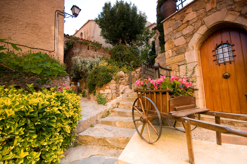 Beautiful street with colorful flowers at Tossa de Mar, Costa Brava, Catalonia, Spain