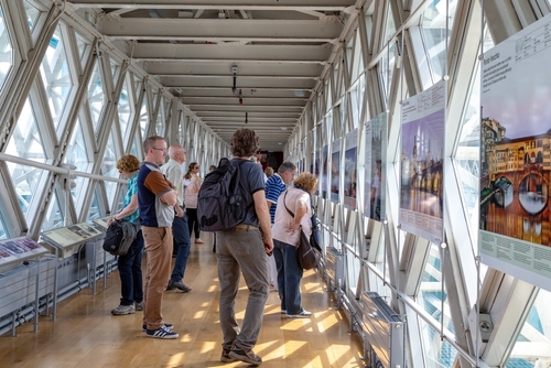 Visitors examining the exhibition at the observation deck of the Tower Bridge, London, England, UK