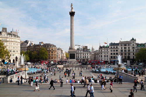 People visiting Trafalgar Square in London, England, United Kingdom. One of the most popular tourist attraction on Earth with millions of visitors a year