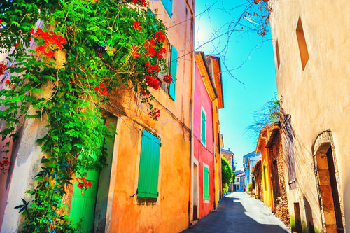 Colorful architecture with blooming flowers on the street in Valensole, Provence, France