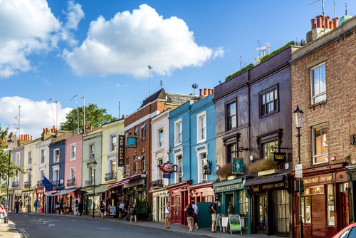 Visitor watches shop windows in Notting Hill, London, England, United Kingdom. Portobello Road Market at Notting Hill currently is one of the top shopping destinations in London