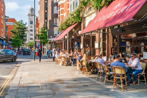 People enjoy sunny spring day in Chelsea, an affluent area known for the smart boutiques and high-end restaurants lining busy King's Road in London, England, United Kingdom