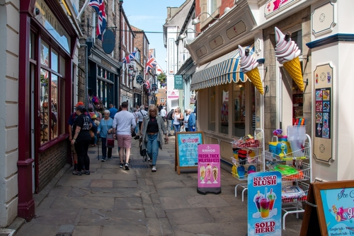 Tourist shopping street in a typical English market town in Whitby, North York Moors National Park, Yorkshire, England, United Kingdom
