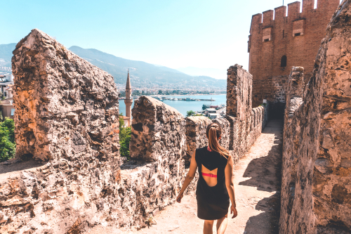 Woman walking amongst the ruins of Alanya castle in Alanya, Antalya, Turkey