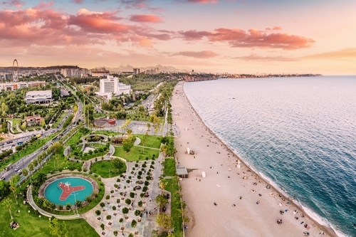 Aerial view of a beach park with vacationers in Antalya, Turkiye. Mediterranean sea coast and riviera