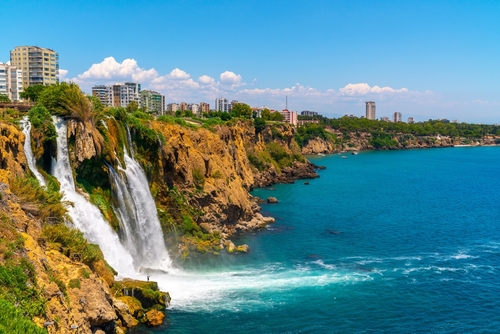 Lower Düden Falls drop off a rocky cliff falling from about 40 m into the Mediterranean Sea in amazing water clouds in Antalya city, Antalya, Turkey