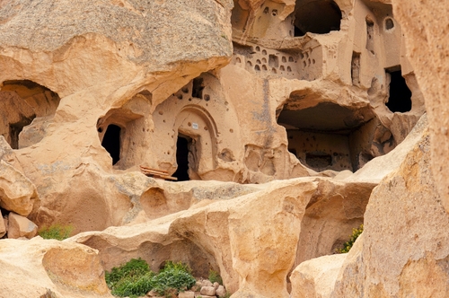 From below close-up shot of cave dwellings of Cappadocia, Goreme National Park of Nevsehir, Turkey. Cave house architectures of Cappadocia