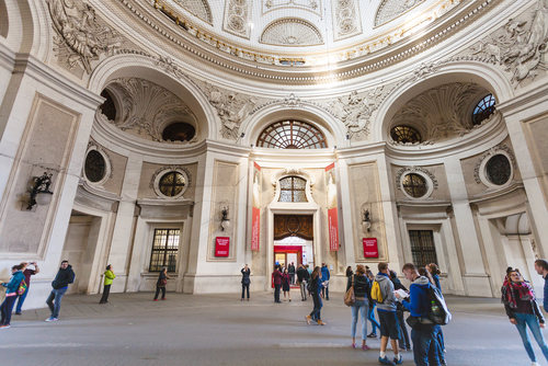 Visitors in the courtyard of Hofburg Palace near doors in Empress Sisi apartments. Since 1994 the Sisi Museum has been housed in the Stephan apartments of Hofburg Palace, Vienna, Ausria