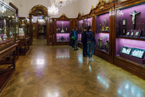 Visitors in halls with religious artifacts in the Imperial Treasury or Kaiserliche Schatzkammer at the Hofburg Palace, Vienna, Ausria