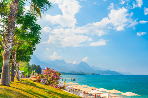 Beautiful beach with green trees in Kemer, Antalya, Turkey. Summer landscape, travel and vacation