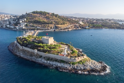 Aerial view of Guvercinada Island (Pigeon Island) with scenic castle at Kusadasi, Turkey. The large resort town is a popular tourist destination in Izmir, Turkey