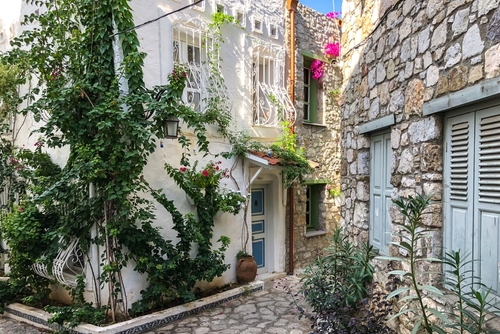 Narrow street in old town of Marmaris, Antalya, Turkey. Beautiful scenic old ancient white houses with flowers. Popular tourist vacation destination