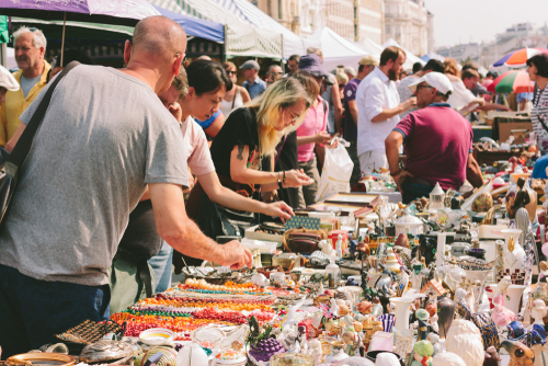Local people and lots of tourists visit the market and looking for bargains and antique stuff at the flea market of Naschmarkt in Vienna, Austria