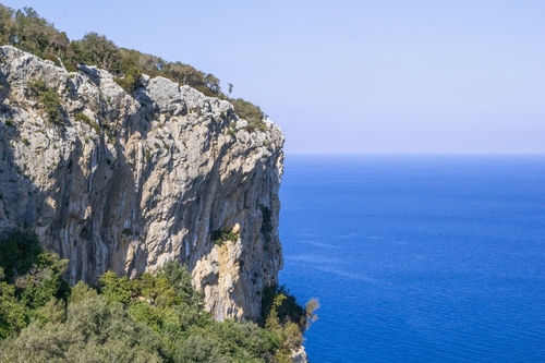 High cliff overlooking blue mediterranean sea on a sunny day. Spectacular views for adventure, Kemer, Antalya, Turkey