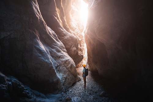 Happy alone woman wearing helmet for safety is engaged in active canyoning and hiking along the Saklikent Gorge near Kemer, Antalya, Turkey