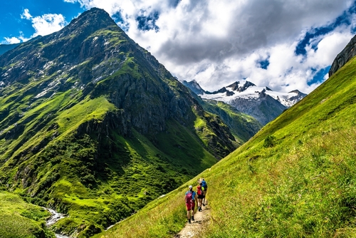 Hiking Group in Valley Of Umbalfaelle On Grossvenediger With View To Mountain Roetspitze In Nationalpark Hohe Tauern, near Salzburg, Tyrol, Austria