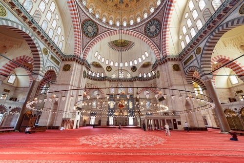 Interior view of the prayer hall in the Suleymaniye Mosque, Istanbul, Turkey. The Ottoman imperial mosque is a popular destination among tourists and pilgrims