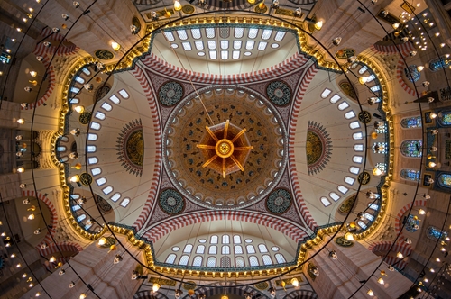 Interior view of the ceiling with Islamic patterns in the Suleymaniye Mosque, Istanbul, Turkey. The Ottoman imperial mosque is a popular destination among tourists and pilgrims