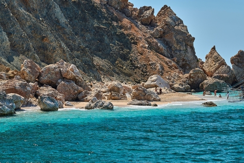 Beautiful landscape of Suluada with its turquoise waters, boats and people swimming. Taken during yacht boat tour from Adrasan, Antalya, Turkey