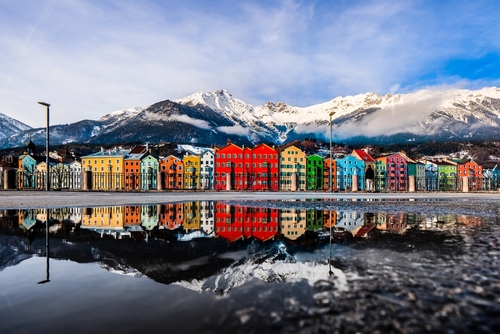 Water reflection of the famous Mariahilf houses and Nordkette of Innsbruck, Austria captured from Marktplatz showing the beautiful alpine landscape
