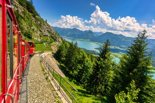 Amazing view of Wolfgangsee lake from Schafbergbahn mountain train, Salzkammergut, Salzburg, Austria. Journey to the top of Alps through lush fields and green forests