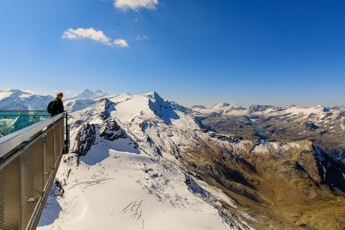 Man overlooking the mountains with snow at the Kitzsteinhorn, Salzburg, Austria