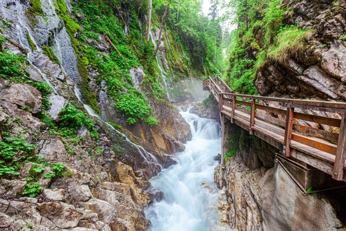Hiking trough the natural spectacle Wimbachklamm Gorge in the mountaineering village Ramsau near Berchtesgaden, Bavaria, Germany. Wimbachtal lies at the foot of the Watzmann. Wimbachklamm is 200 meters long