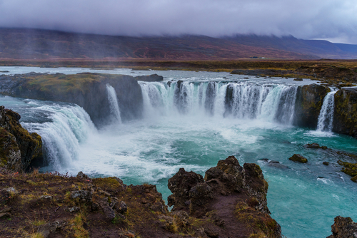 View of Goðafoss waterfall on a gloomy and misty autumn afternoon, north Iceland