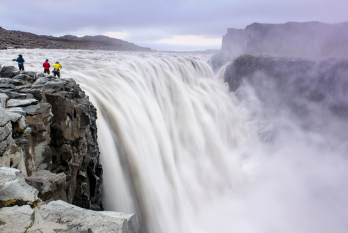 The most powerful waterfall in Europe, people standing close to the majestic Dettifoss in Iceland. Jokulsargljufur National Park, Jokulsa a Fjollum river