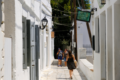 People walking on a typical narrow street in the village of Apiranthos on Naxos Island, Cyclades Islands, Greece