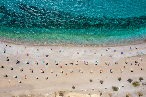 Aerial top down view of the beach and its facilities in the Glyfada district, south Athens Riviera, Greece
