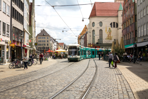 View of people and a tram at the Marketplace of Augsburg. Augsburg is the third-largest city in Bavaria, Germany