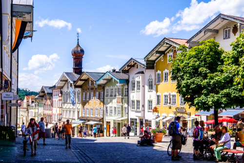 People walking among the famous old facades with historic murals in the old town of Bad Toelz, Bavaria, Germany