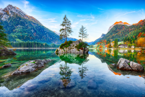 Fantastic autumn sunrise of Hintersee lake. Beautiful scene of trees on a rock island. National park Berchtesgaden, Bavaria, Germany