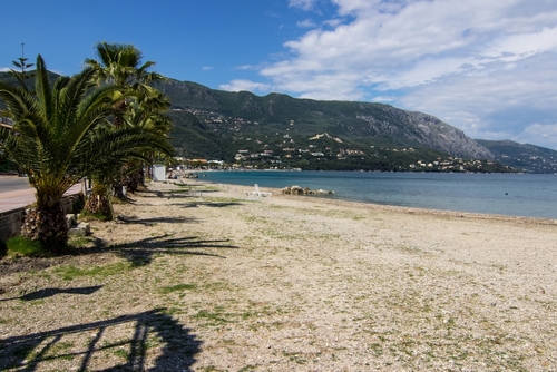 Picturesque marina and beach in the small coastal town of Ipsos on Corfu Island, Ionian Islands, Greece