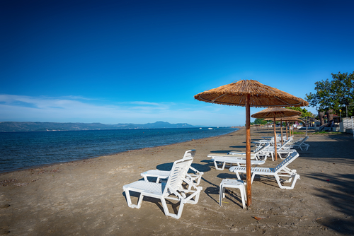 View of a beach and its facilities in Kavos, a seaside village on the island of Corfu, Ionian Islands, Greece